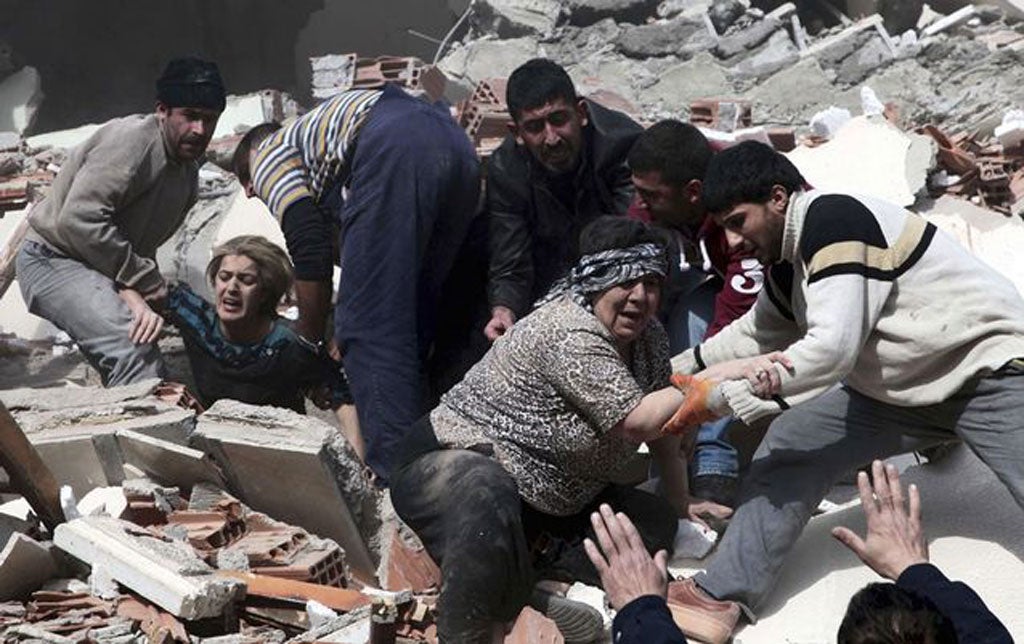 Rescue workers rescue people trapped under debris after an earthquake in a village near the eastern Turkish city of Van. Turkey's Kandilli Observatory estimates that some 500 to 1,000 people were killed in a powerful earthquake in southeast Turkey's Van p