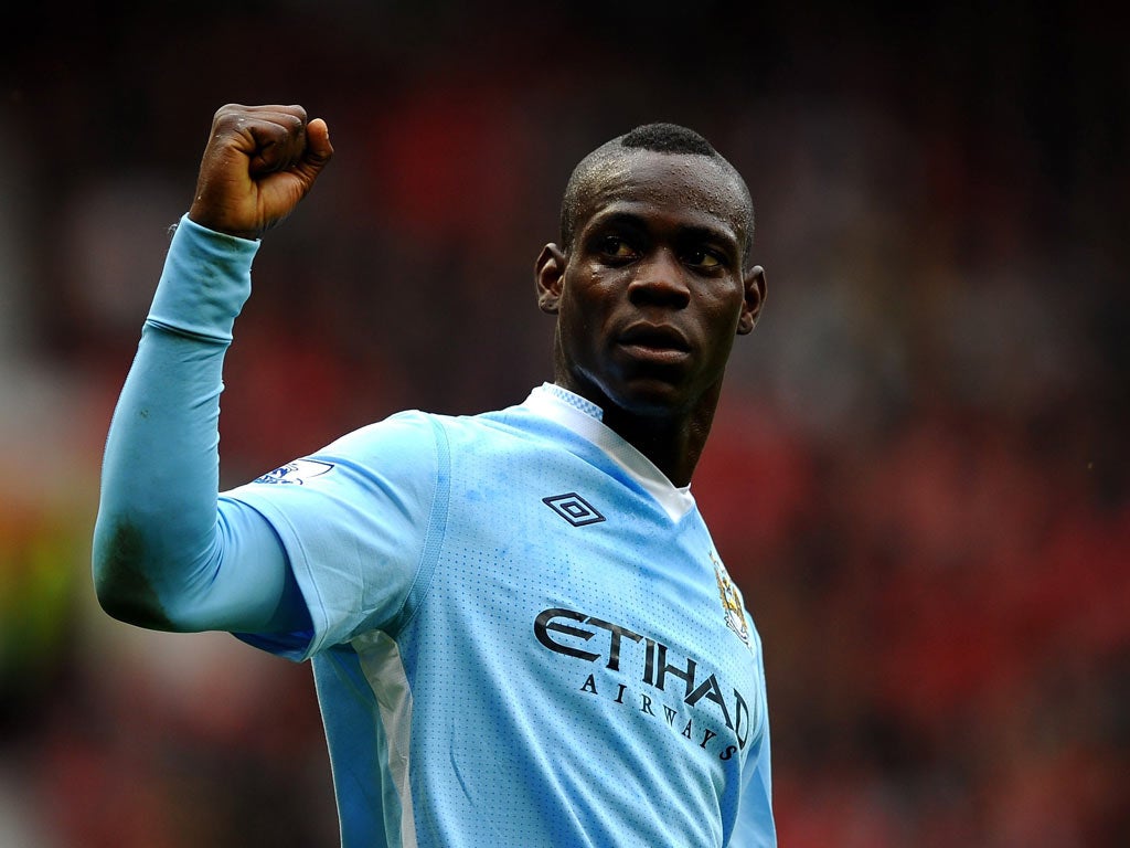 Mario Balotelli celebrates scoring his team's second goal