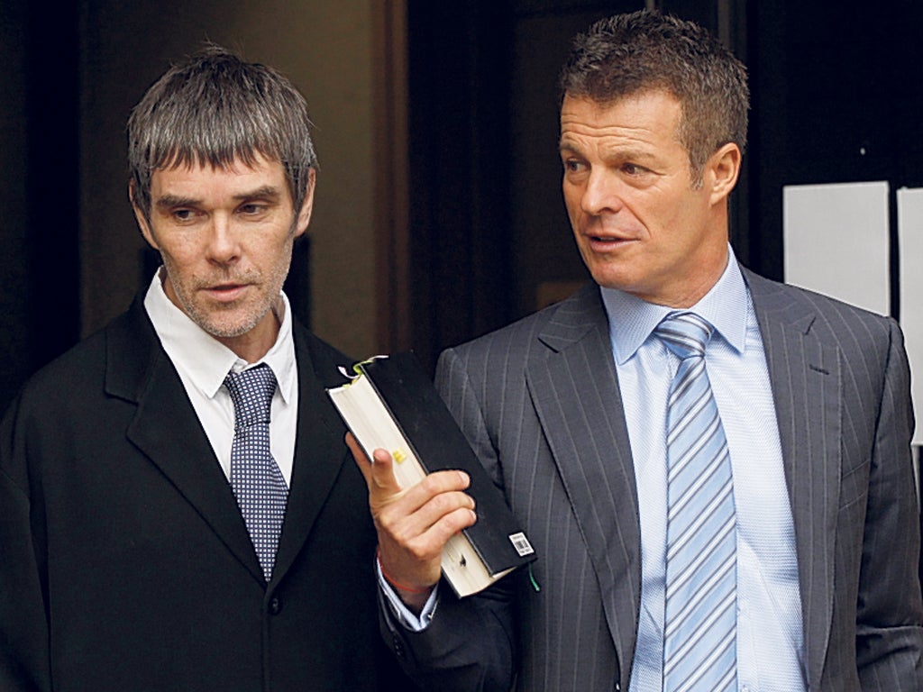 Ian Brown, lead singer of the Stone Roses, leaves court yesterday with his solicitor 'Mr Loophole' Nick Freeman