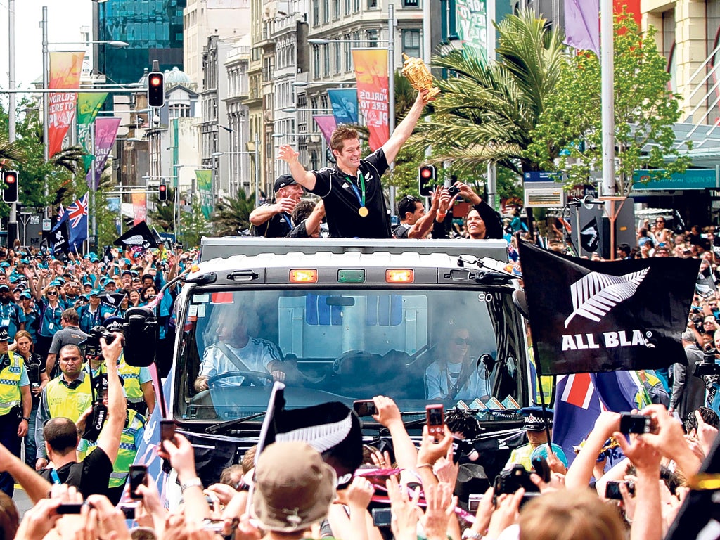 The All Blacks' Richie McCaw parades the Webb Ellis Trophy in Auckland yesterday