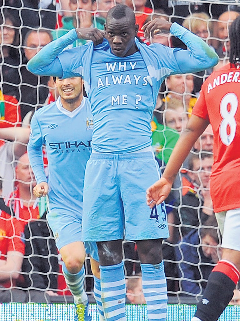 Mario Balotelli reveals his 'Why Always Me?' T-shirt at Old Trafford. He won't be wearing another one though: 'No, because otherwise I'll get booked every week,' he grinned