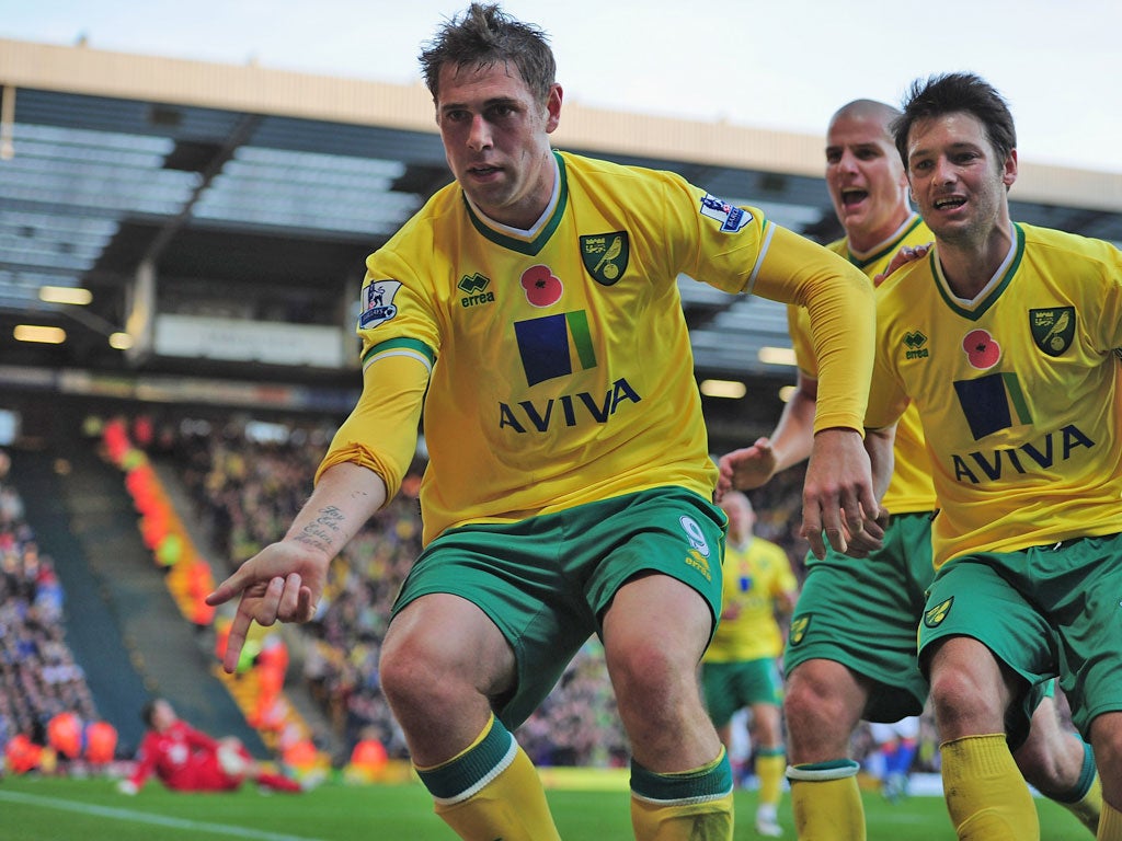 Norwich's Grant Holt runs to the fans to celebrate after his late penalty earned his side a point and continued their fine start to the season