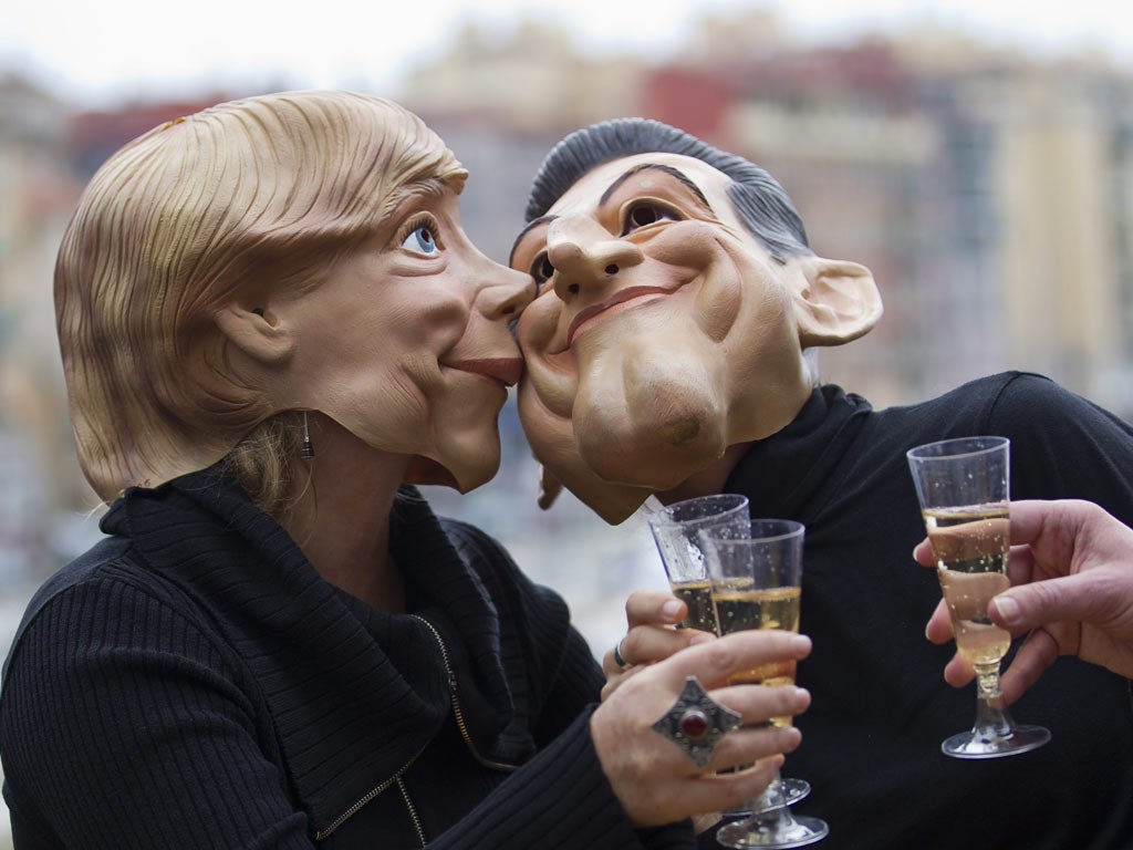 G20 activists wearing Merkel and Sarkozy masks