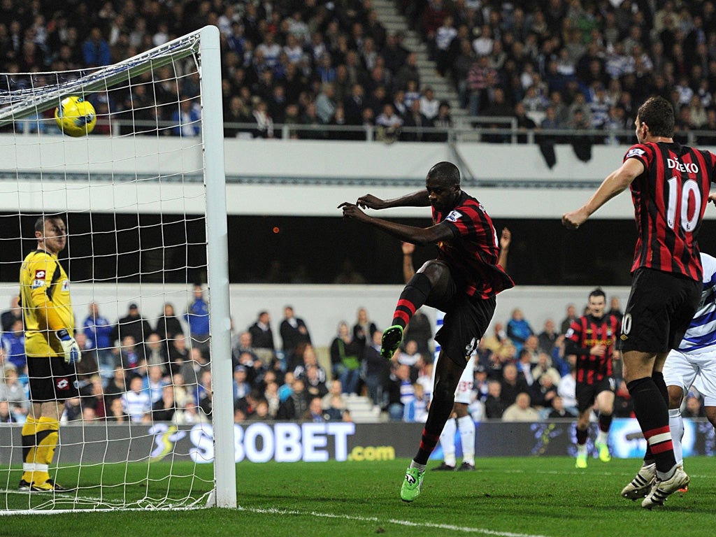 Earning his stripes: Yaya Touré smashes the ball into the back of the Queens Park Rangers net in celebration after his header wins the game for Manchester City at Loftus Road last night