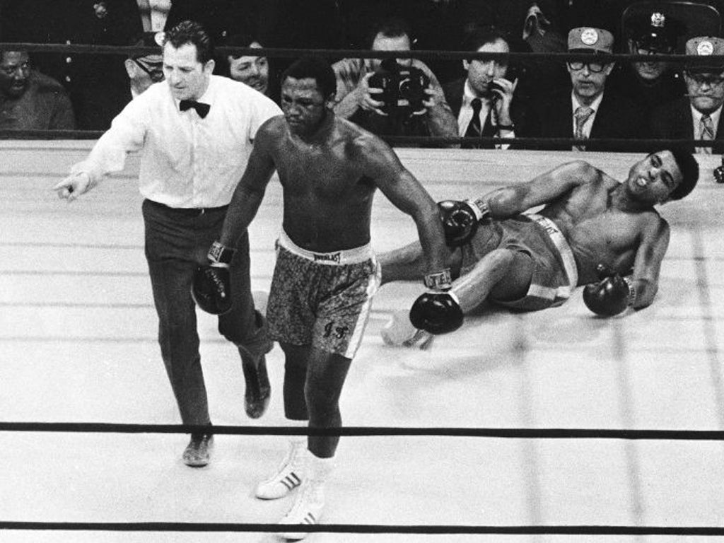 Joe Frazier being directed to the ropes by referee Arthur Marcante after knocking down Muhammad Ali during the 15th round of the title bout at Madison Square Garden in New York in 1971