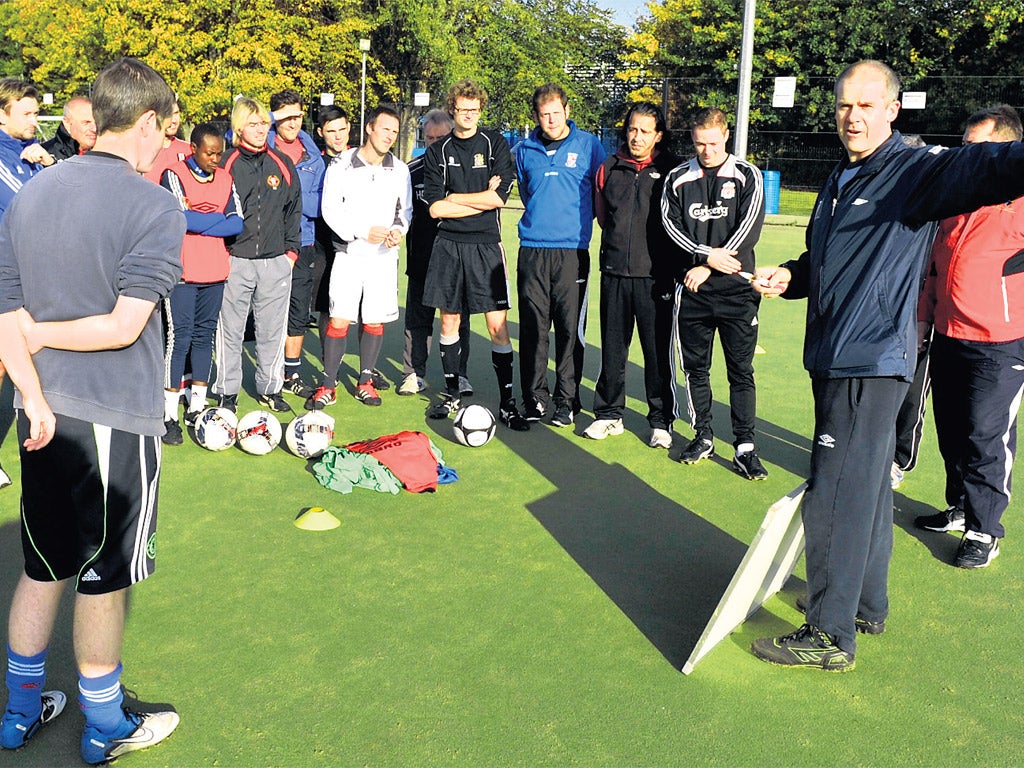 Glenn Moore (right) tries to get his point across during a coaching session