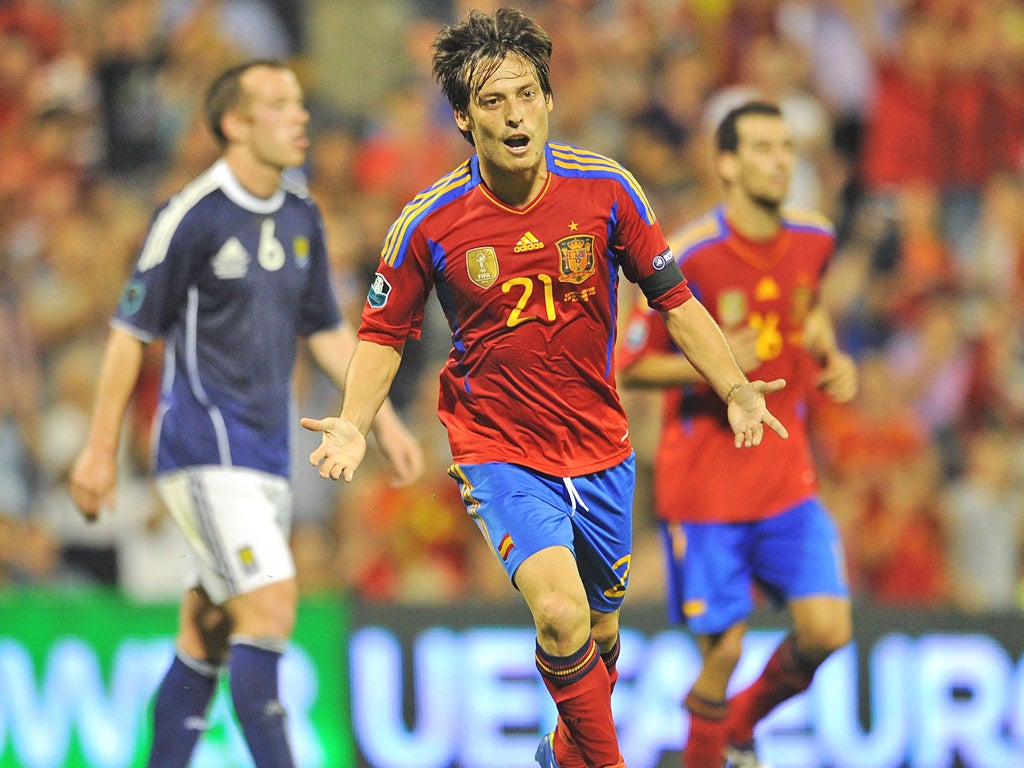 David Silva celebrates scoring his side's second goal against Scotland last month