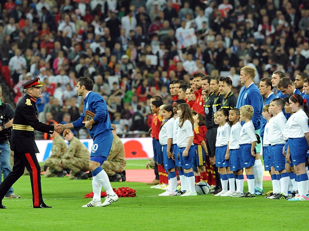 England's captain against Spain, Frank Lampard, greets a member of the armed forces at Wembley as part of a weekend of remembrance