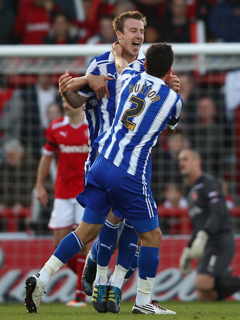 Chris Lines, the midfielder celebrates with Lewis Buxton
after scoring the first for the Owls at Morecambe