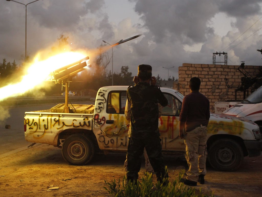 Fighters from Zawiya city fire a rocket towards the Warcfana tribe about 40km outside Tripoli