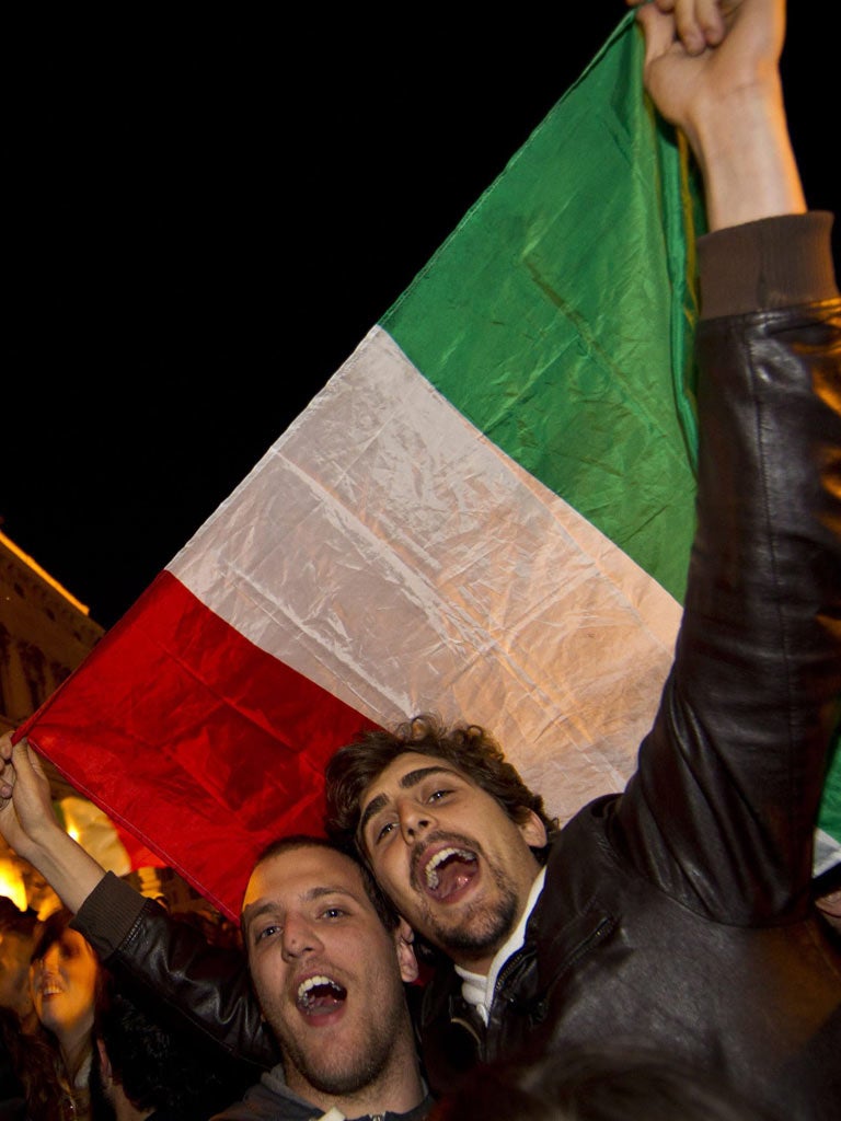 Italians celebrate the promise of a new dawn after Prime Minister Silvio Berlusconi announces his resignation