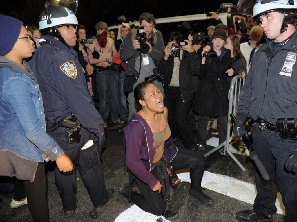 A woman yells at New York Police Department officers as New York City officials clear the 'Occupy Wall Street' protest from Zuccotti Park