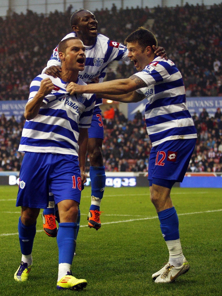 Shaun Wright-Phillips and Heidar Helguson celebrate Luke Young’s goal