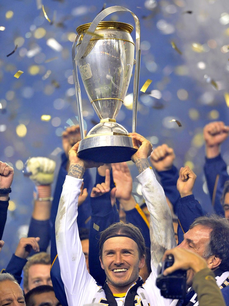 David Beckham lifts the MLS trophy for LA Galaxy after defeating Houston Dynamo on Sunday