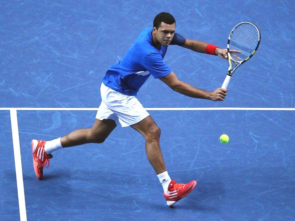 Jo-Wilfried Tsonga returns the ball against Mardy Fish