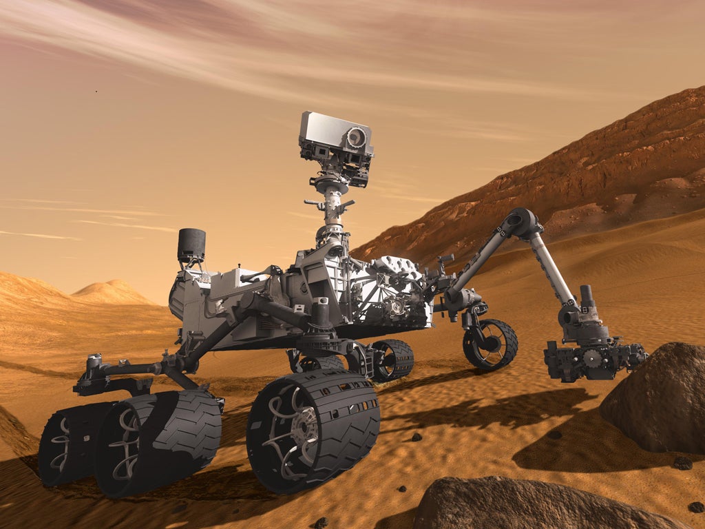 An artist's impression of the Mars Science Laboratory's robot, Curiosity, at work on the surface of Mars