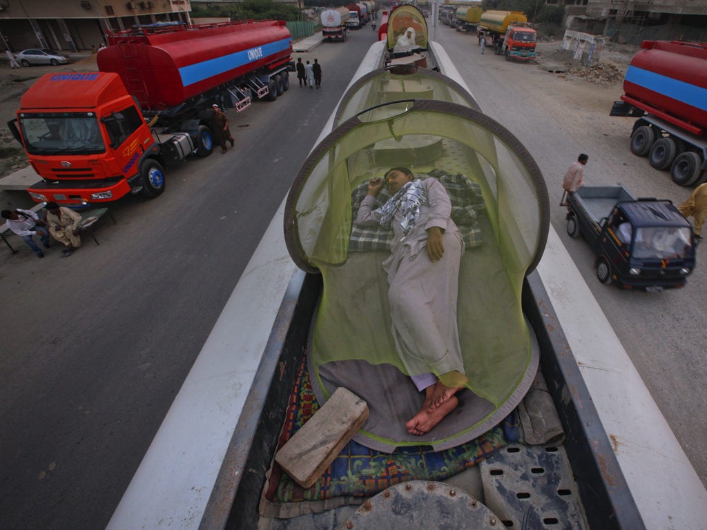 Drivers of Nato supply lorries take a nap yesterday while queuing outside Quetta in Pakistan's Baluchistan province after the border crossing at Chaman was closed