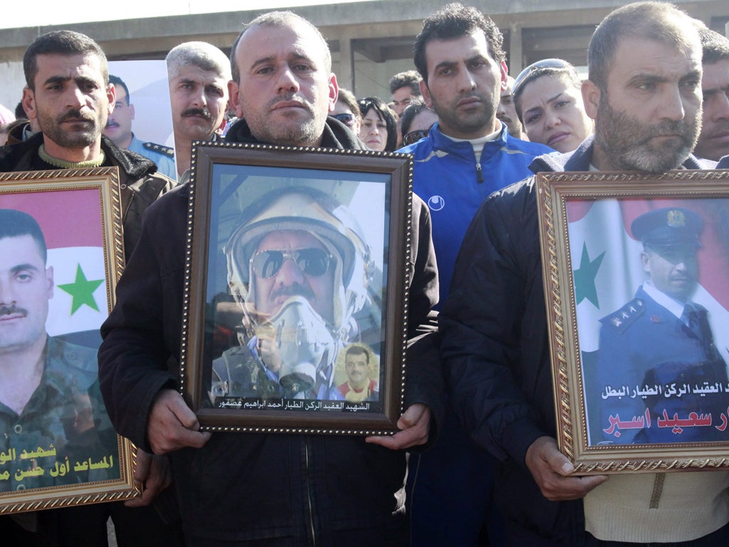 Relatives of military personnel killed during the past two days of upheavals in Homs