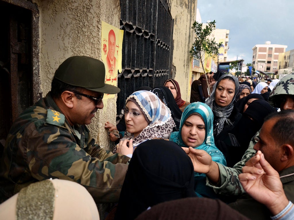 Soldiers police the entrance to a polling station in Alexandria yesterday
