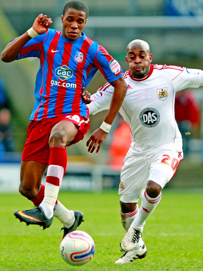 Palace's Wilfried Zaha (left) battles for the ball with Jamal Campbell-Ryce of Bristol City in the Championship at Selhurst Park