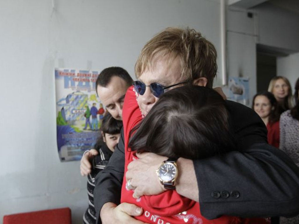 Scenes from Kiev: Elton John hugs a patient at a drop-in centre funded by his Aids Foundation