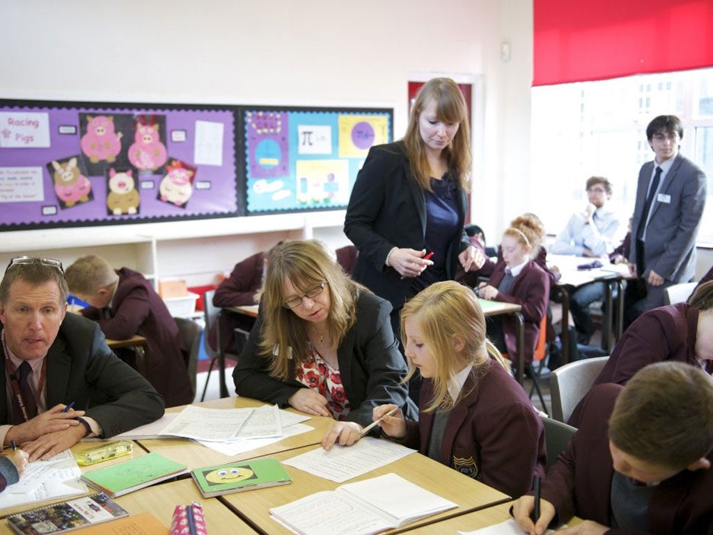 Centre of learning: a university tutor oversees her students teaching at Ashton-on-Mersey school