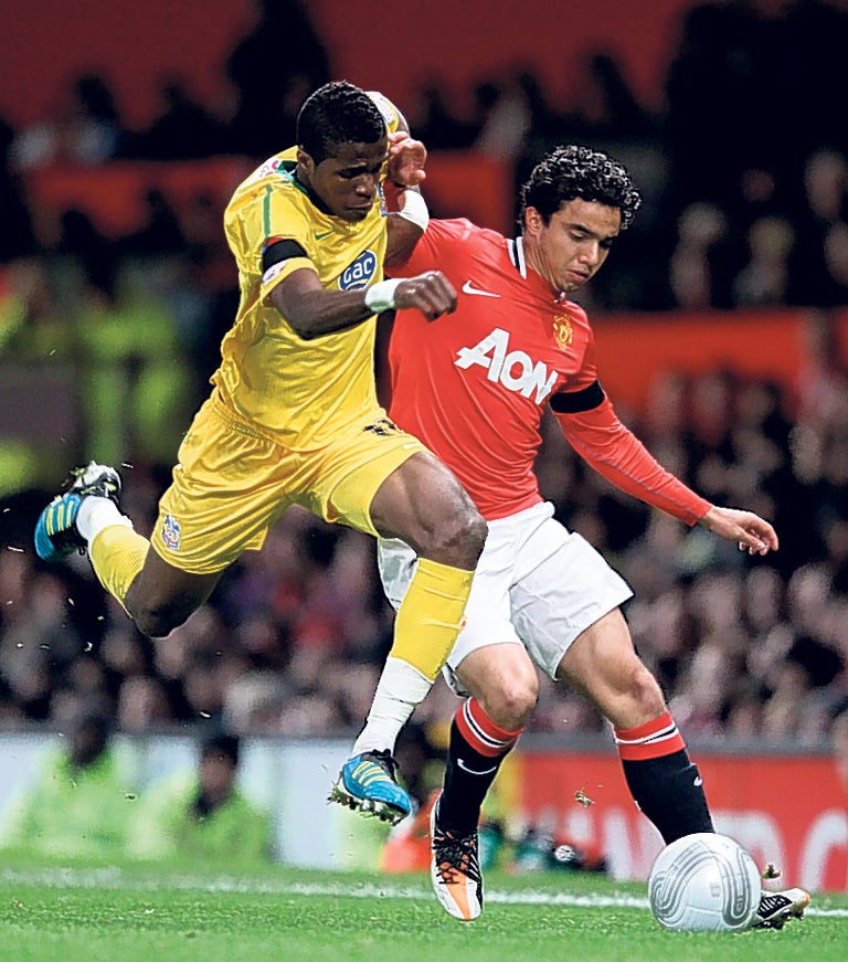 Crystal Palace's Wilfried Zaha (left) takes on Fabio da Silva