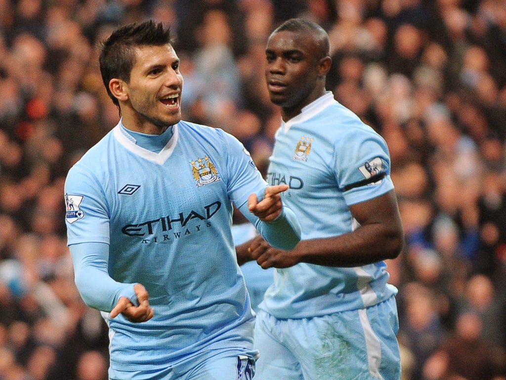 Sergio Aguero celebrates with teammate Micah Richards