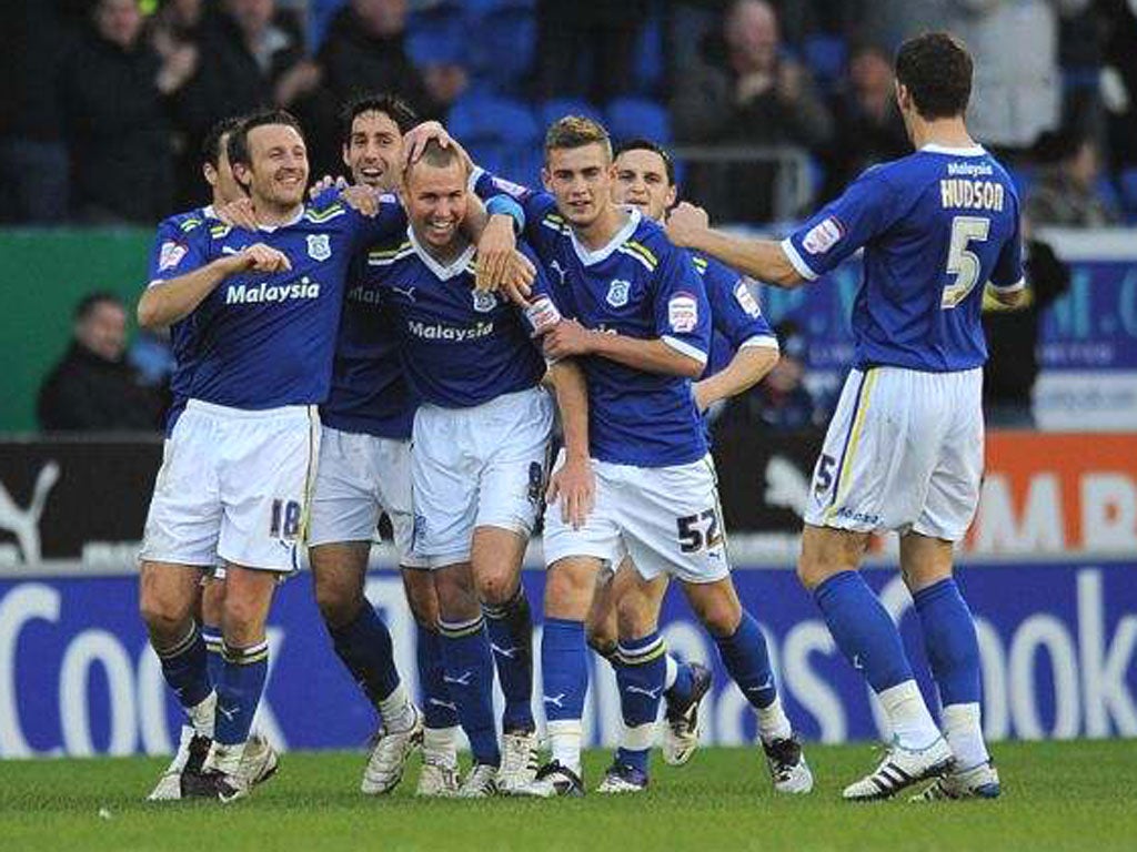 The Cardiff City players congratulate Kenny Miller (centre) after the Scottish striker got the winner against Birmingham City yesterday