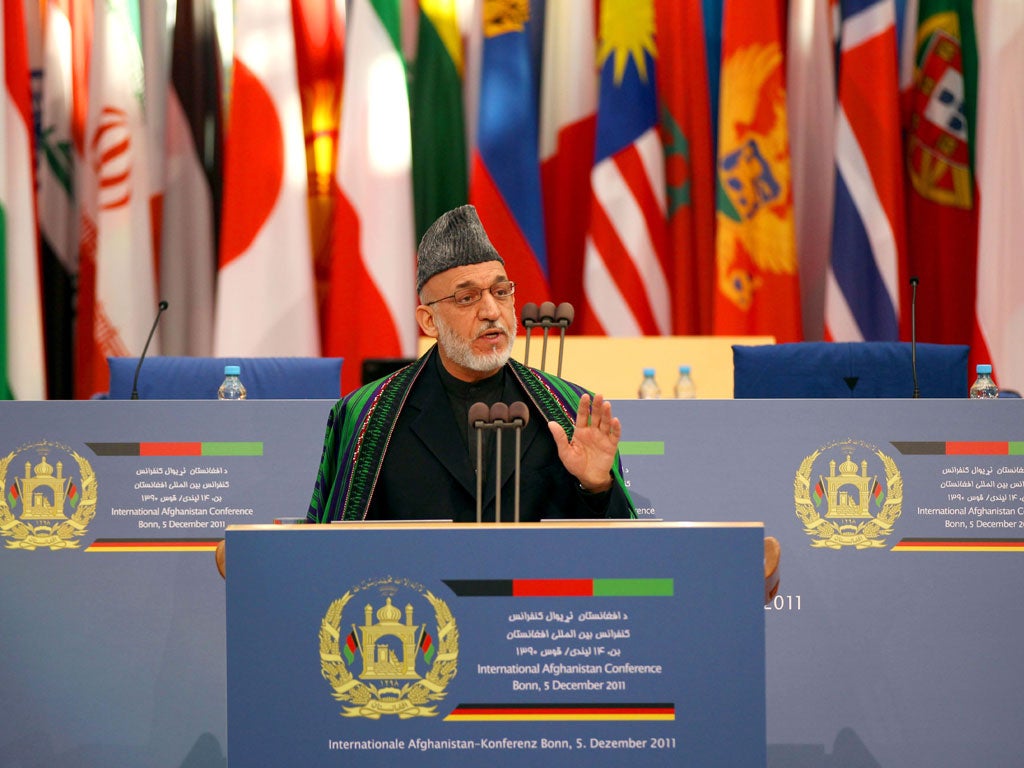 Hamid Karzai at the Bonn summit yesterday. He has insisted that he will relinquish the presidency in 2014