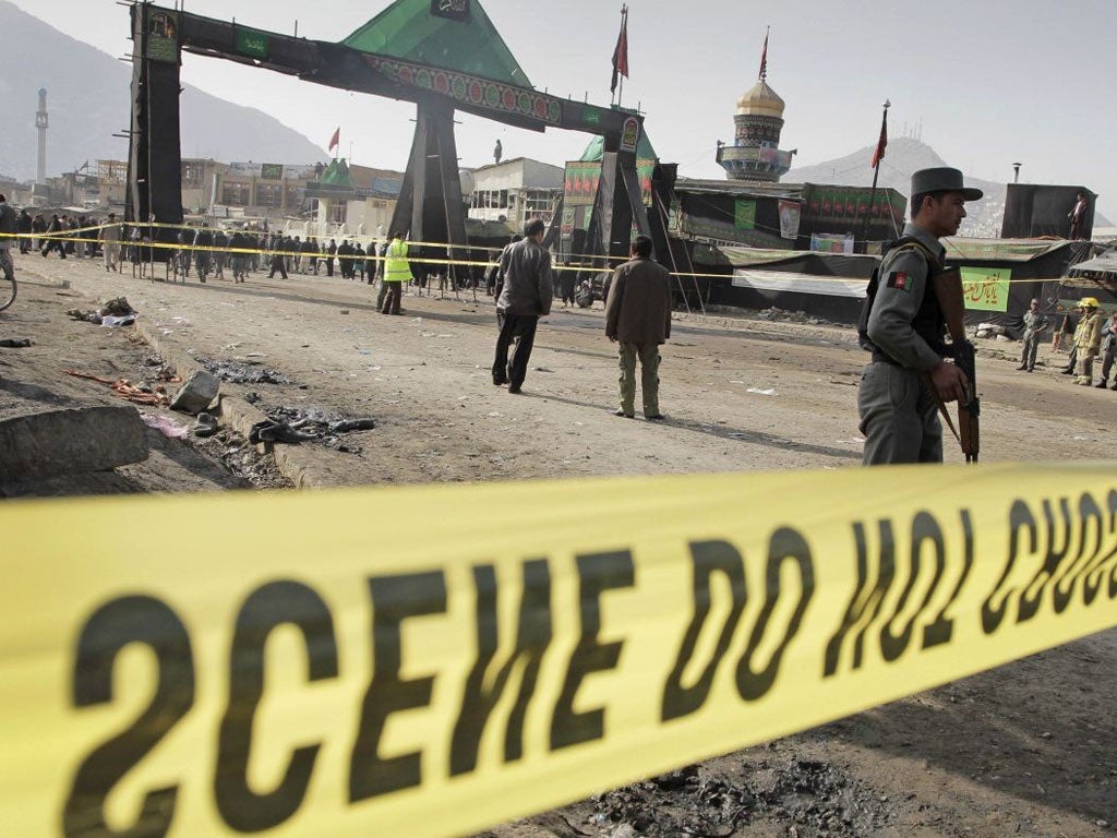 A police officer outside the Shiite shrine in Kabul