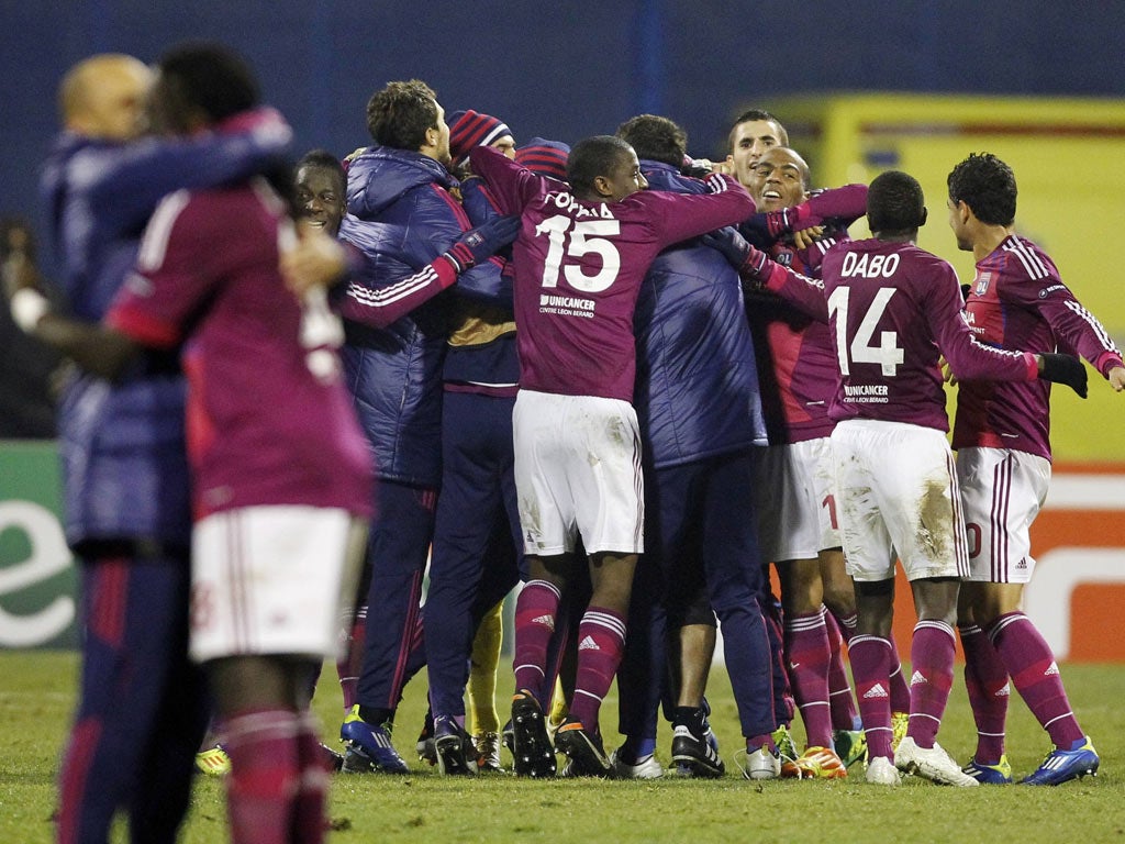 Lyon celebrate after they booked their place in the knock-out stage