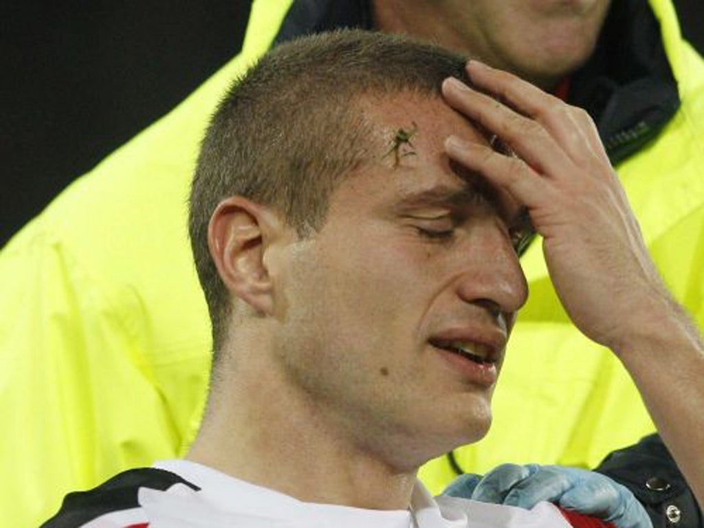 Nemanja Vidic is carried off with hisk nee injury against Basle