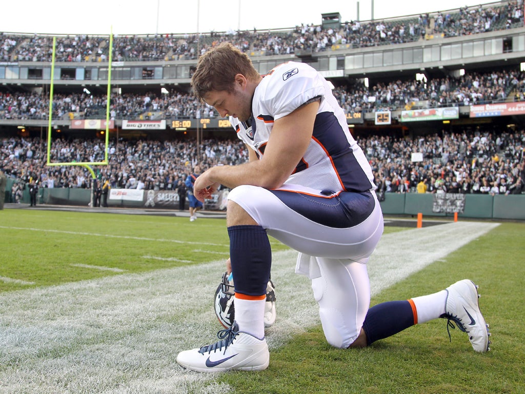 Tim Tebow gives thanks in his trademark pose which has become known as 'Tebowing' and swept across America via YouTube