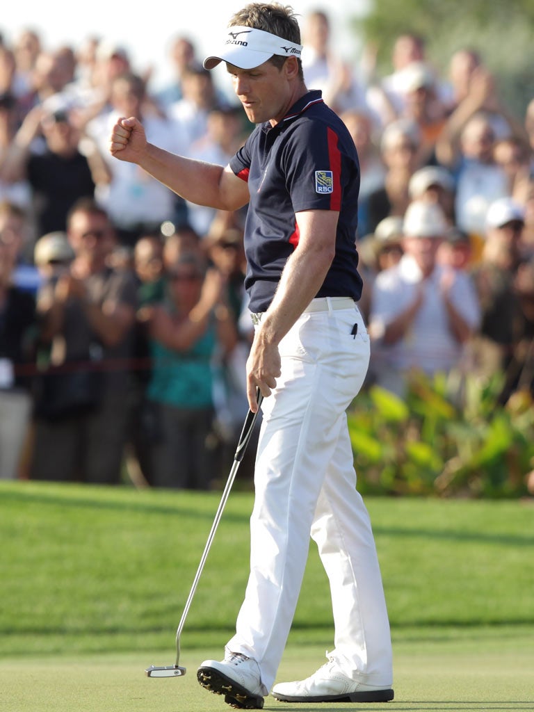 Luke Donald on the18th green after sinking a putt for a birdie