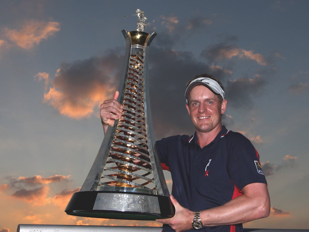 Luke Donald celebrates with the Race to Dubai trophy