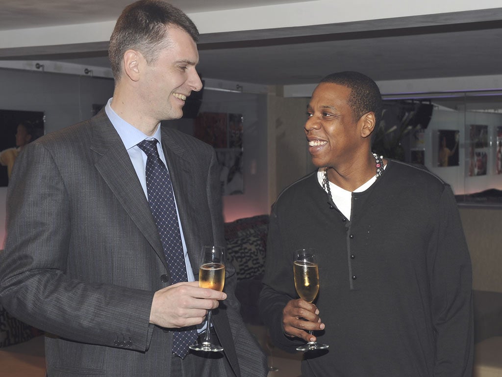 Mikhail Prokhorov celebrates his takeover of the New Jersey Nets with Jay-Z in New York in May last year