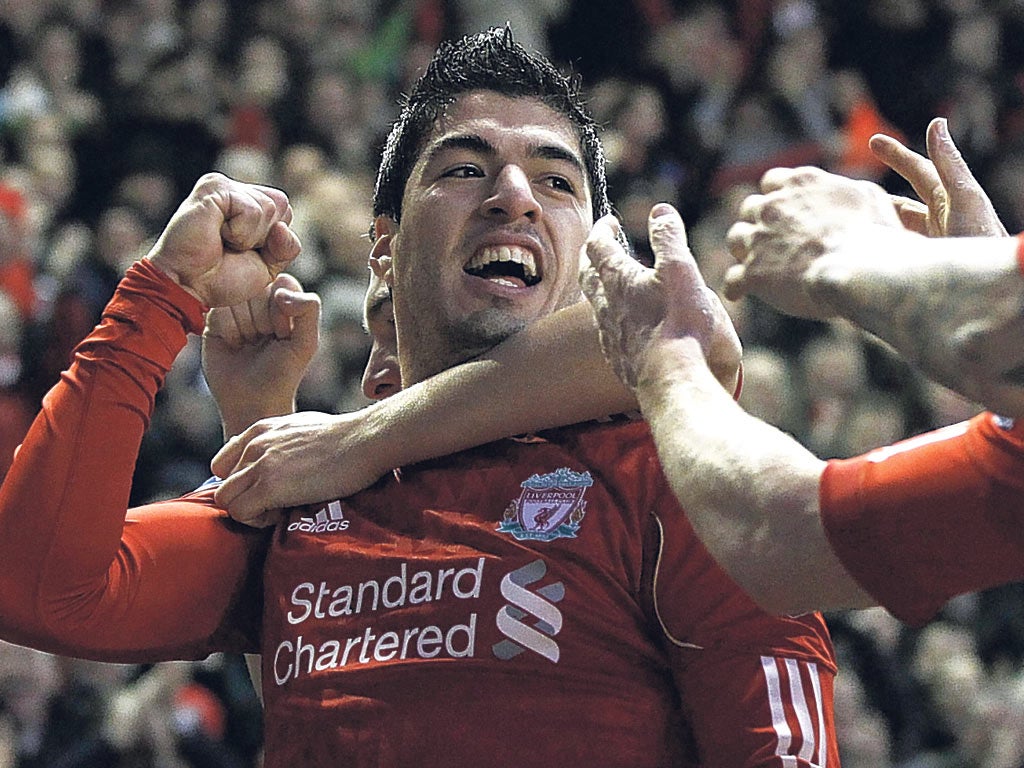 Luiz Suarez celebrates scoring against QPR on Saturday but faces an FA disciplinary commission today