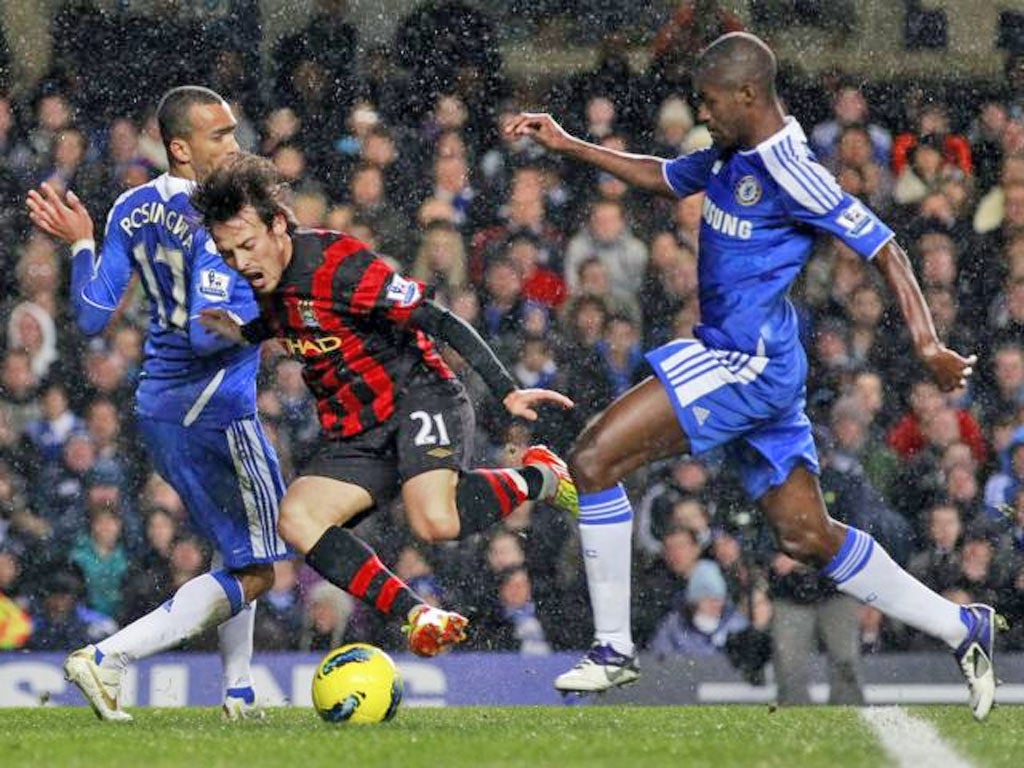 Manchester City’s David Silva falls in the Chelsea box – much to the annoyance of the Stamford Bridge crowd