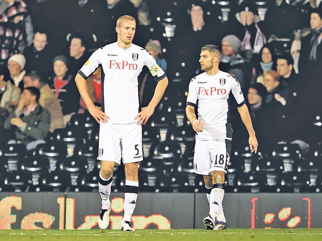 Brede Hangeland (left) and Aaron Hughes can hardly believe Fulham’s elimination