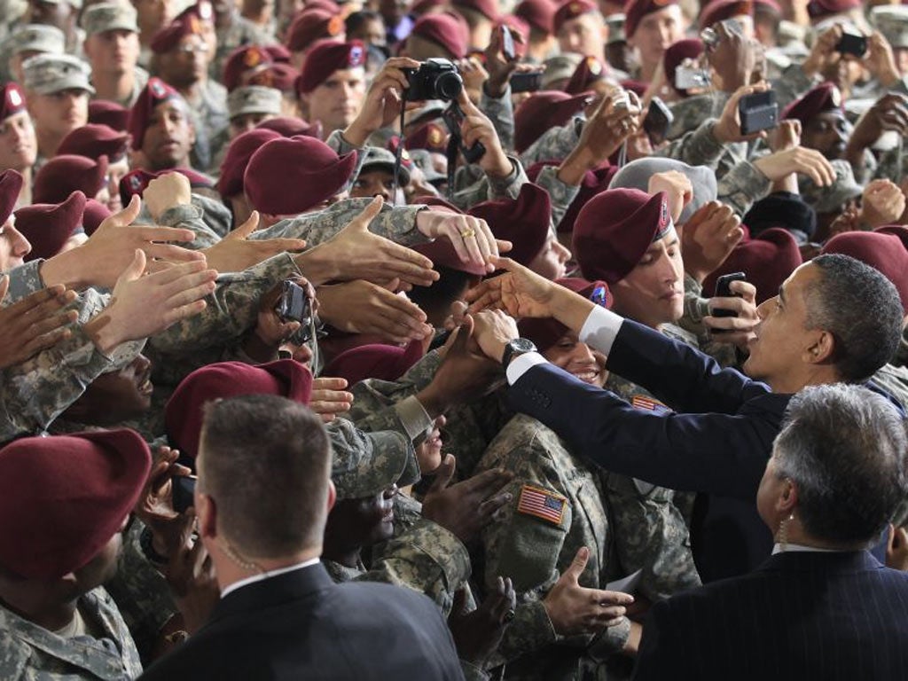 Barack Obama greets troops at Fort Bragg, North Carolina, declaring the conflict had ended honourably
