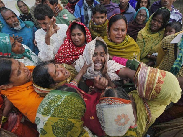 Family members mourn their relatives who died after consuming bootleg alcohol