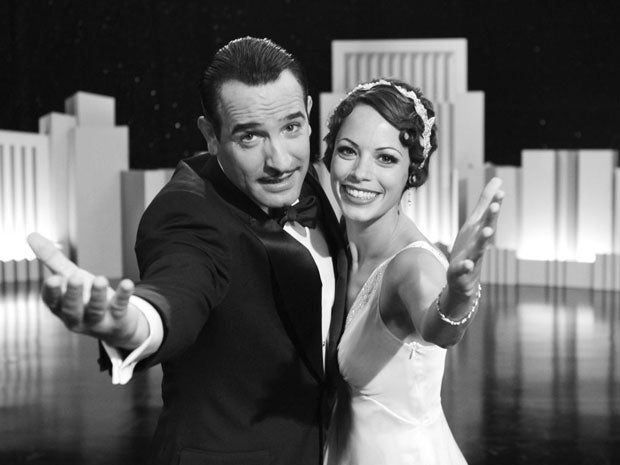 Jean Dujardin portrays George Valentin, left, and Berenice Bejo portrays Peppy Miller in a scene from The Artist