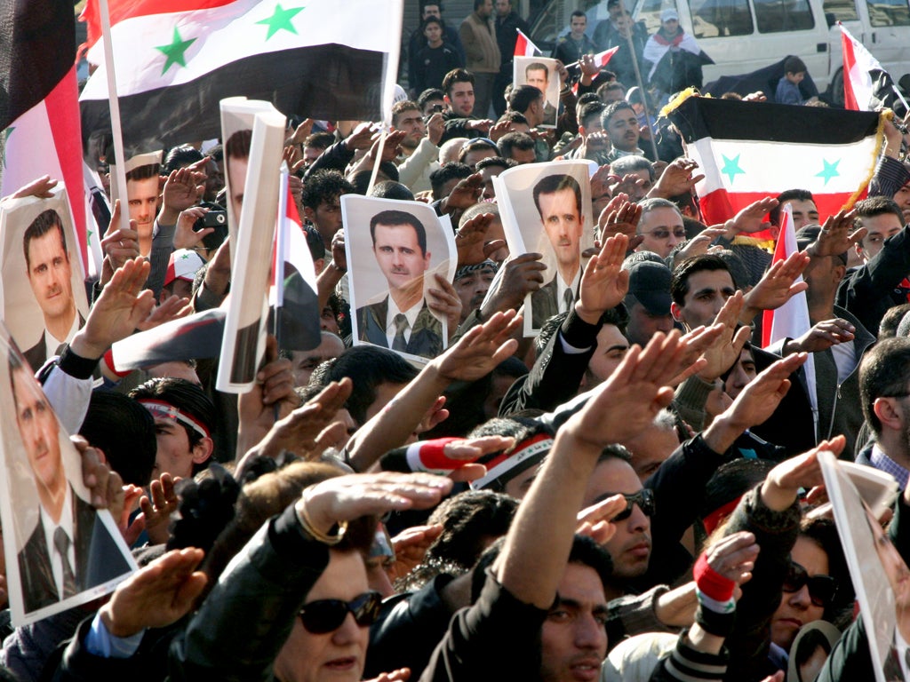 Assad supporters hold a counter-rally in Damascus yesterday