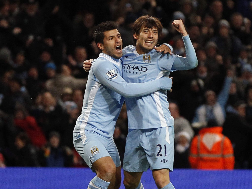 David Silva celebrates with Sergio Aguero (far left) after scoring Manchester City's winner