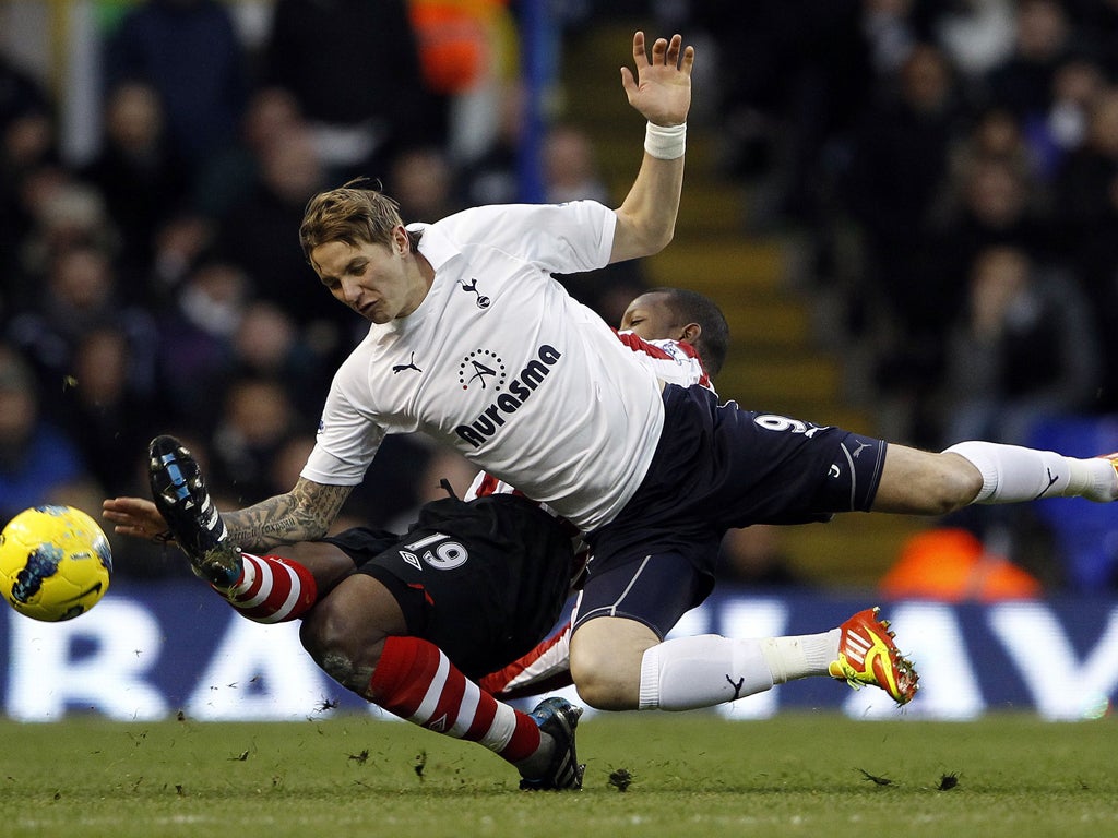 Tottenham's matchwinner Roman Pavlyuchenko gets into a tangle with Sunderland's Titus Bramble