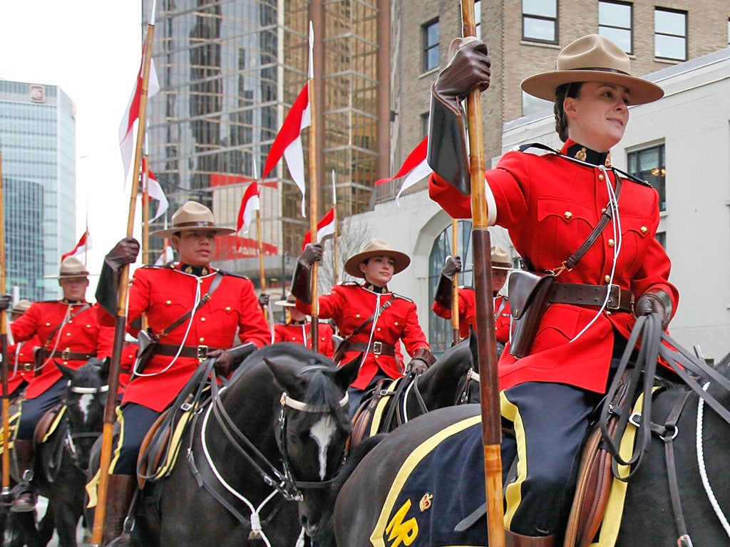 <p>Mounties stage a horseback parade through downtown Vancouver</p>