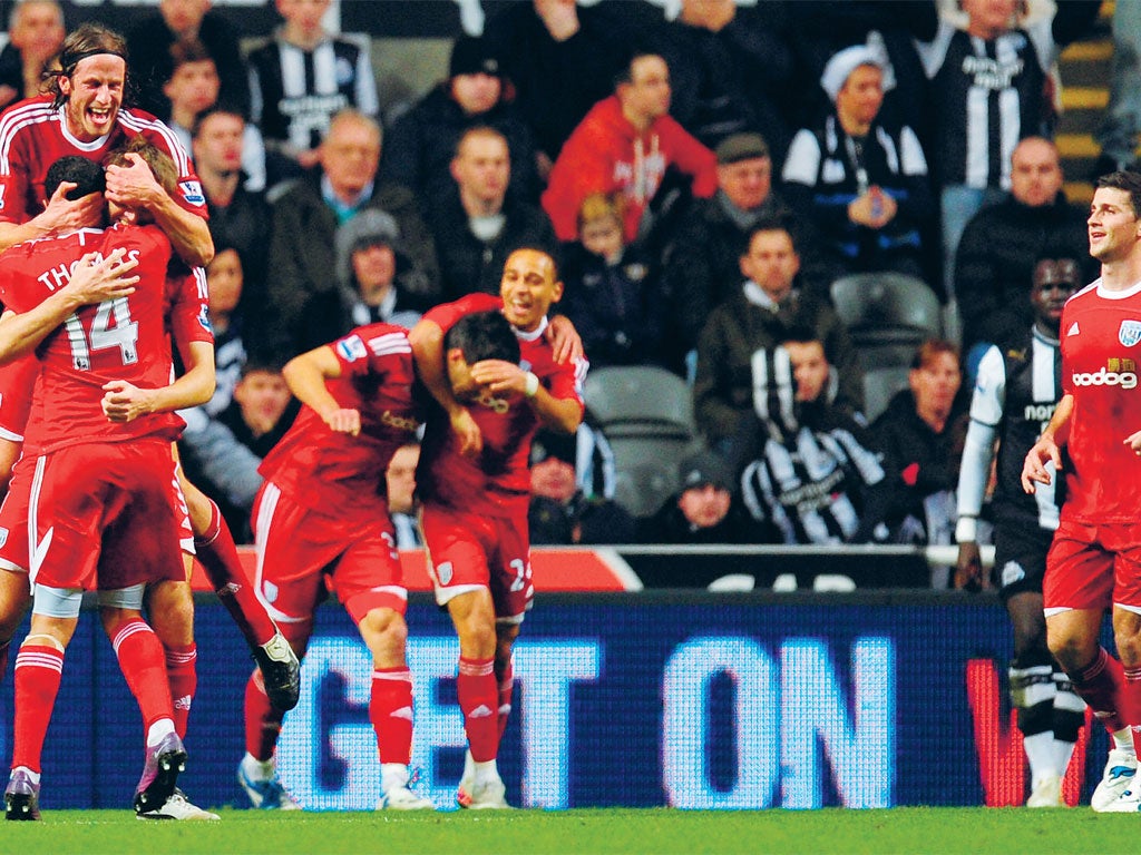 West Bromwich Albion players celebrate Gareth McAuley's (centre) goal at St James' Park
