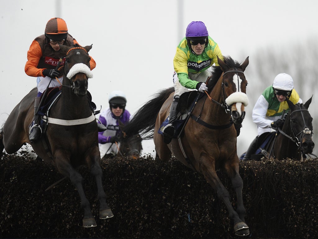 Sam Waley-Cohen on Long Run (left) jumps alongside Kauto Star (Tony McCoy) before winning last season