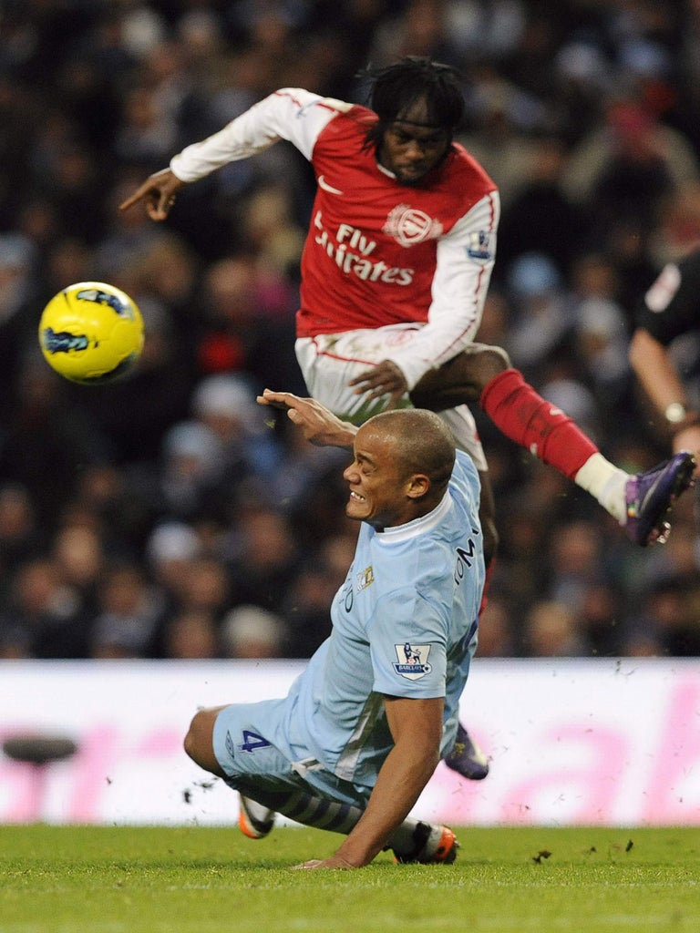 Manchester City's Vincent Kompany (left) and Arsenal's Gervinho